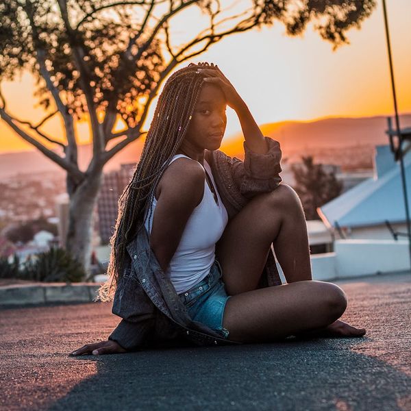 Person looking contemplative and relaxed in a peaceful environment.